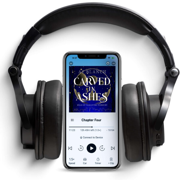 Phone and headphones with the audiobook of Carved in Ashes on the screen
